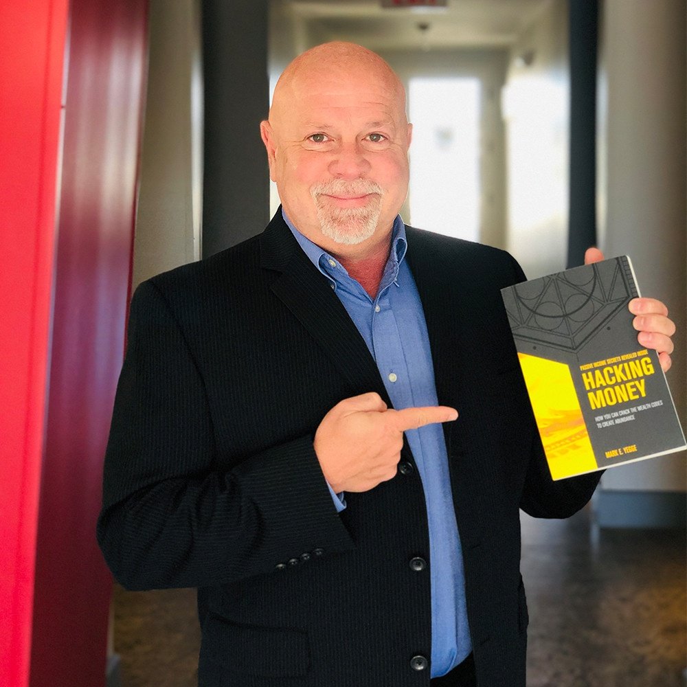 Mark Yegge holding one of his books